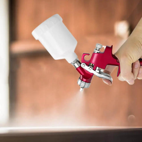 Heavy Duty Air Spray Gun With A Snazzy 600Cc Cup And Precise 1.5Mm Tip in hand showing detailed ergonomic design and spray action.
