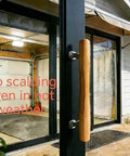 Natural Solid Wood Sliding Patio Door Handle With Ergonomic Curved Grip installed on glass door, exterior view