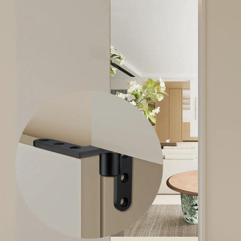 Close-up of stainless steel pivot hinge on a wooden door, showcasing its concealed design and silver-black finish for heavy load capacity.