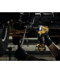 Mechanic using Xtreme 12V Max Brushless One Half Inch Cordless Impact Wrench Tool Only under vehicle, showcasing torque and LED ring.