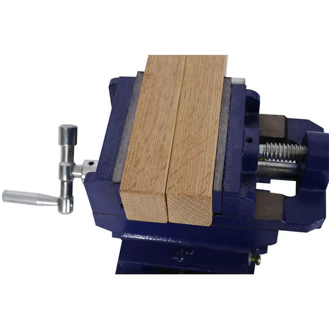 Cross Slide Drill Press Vise With Two Way X Y Precision Control Heavy Duty Cast Iron Milling Clamp holding wood in blue steel