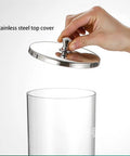 Top Tier 18 Liter Dry Food Dispenser With Six Three Liter Sealed Jars Featuring No Sweat One Ounce Dial Port showing stainless steel top cover.