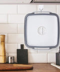 2.4 Gallon Collapsible Dish Basin With Drain Plug For Camping, RV, And Outdoor Use hanging in a kitchen for storage