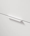 White Modern Cabinet And Drawer Edge Pull Handle Center To Center Five And One Sixteenth Inch 128 Mm installed on cabinet