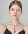 Woman wearing Five Pack Rainbow Wood Acorn Pendant Set With Openable Mini Cremation Urns For Ashes as a necklace, front view