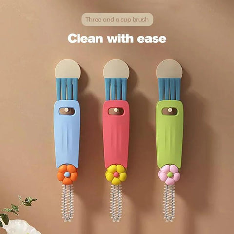 Front view of three 3-in-1 cup lid gap cleaning brushes in blue, pink, and green with flower handles mounted on wall