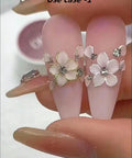 Pro Grade Dual Ended Nail Art Tool Set in use with floral rhinestone design on acrylic nails.