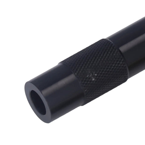 Close-up of Portable 13cm Emergency Fire Piston Fire Starter with black metal body and textured grip, Pocket Sized Survival Gear.