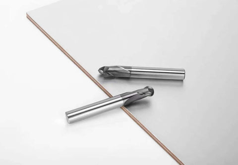 Side view of two 1/8 in ball-nose carbide end mills, 2-flute, on a white surface