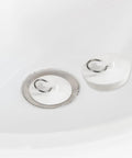 Heavy Duty Rubber Sink Stopper And Bathtub Drain Plugs Built Tough With A Slick Hang Loop in white, 2-inch size, placed in a sink.