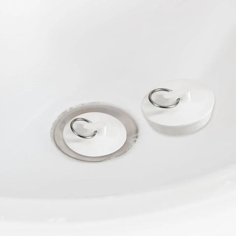 Heavy Duty Rubber Sink Stopper And Bathtub Drain Plugs Built Tough With A Slick Hang Loop in white, 2-inch size, placed in a sink.