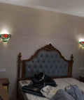 Rose Flower Tiffany Style Stained Glass Wall Sconce Lamp 12 Inch Wide Handmade Home Decor in bedroom setting with warm glow