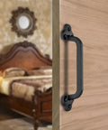 Rustic 9 Inch Cast Iron Sliding Barn Door Handle 2 Pack Black Vintage Gate Pull installed on wooden interior door