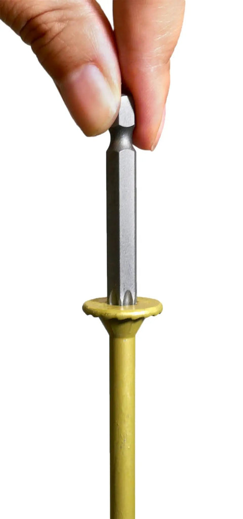 A hand holding a T40 star drive bit for the 50 Pack 5/16 Inch X 4 Inch T40 Star Drive Structural Screws For Decking Framing Heavy Duty Beef No Sweat Self Drilling Installation With Grip Tight Hold And Rustproof Gold Coating.