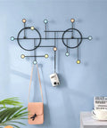 Heavy Duty Wall Mount Coat Hooks Built Tough With Premium Iron Metal hanging bags and camera on a blue wall.