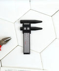 OHPHCALL 2pcs Wheel Hub Diameter Ruler ABS Measuring Tool for Automotive on a tiled surface with pliers.