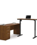 Kick Up Your Office Setup With This Hella Sturdy L Shaped Standing Desk Bundle In Dark Chocolate with height adjustable lift and drawers.