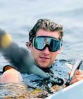 Person wearing Frameless Ultralight Black Mirror Swim Goggles With VisiClear Nanotech Anti Fog Lens And 100 Percent UV Protection