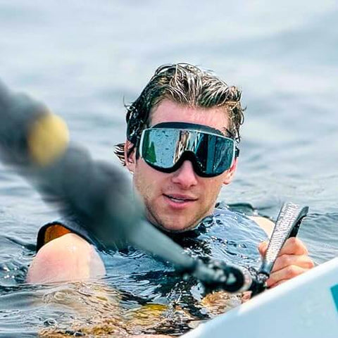 Person wearing Frameless Ultralight Black Mirror Swim Goggles With VisiClear Nanotech Anti Fog Lens And 100 Percent UV Protection
