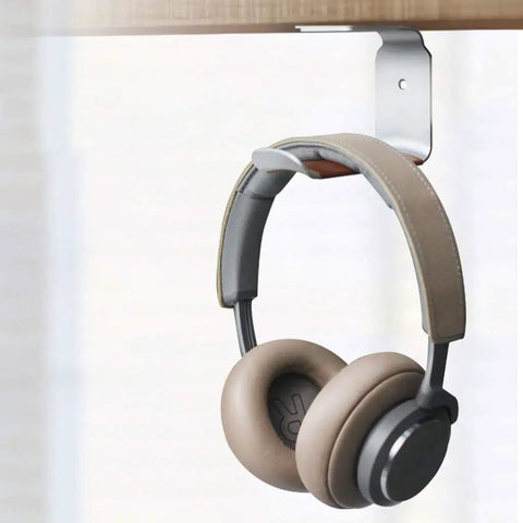 Headphones hanging on under desk headphone stand mount with self adhesive tape L shape headset holder bracket for easy no drill setup and clean cable management black finish.