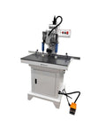 Front view of Banfluxion 110V hinge drilling machine with pneumatic feed, white/gray metal body, orange foot pedal