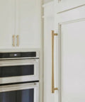 Champagne Bronze Cabinet Pulls Set, 6 Pack, 7.56 Inch Hole Center, modern warm gold drawer handles on a white kitchen cabinet.