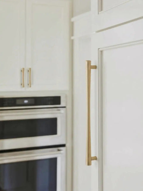 Champagne Bronze Cabinet Pulls Set, 6 Pack, 7.56 Inch Hole Center, modern warm gold drawer handles on a white kitchen cabinet.