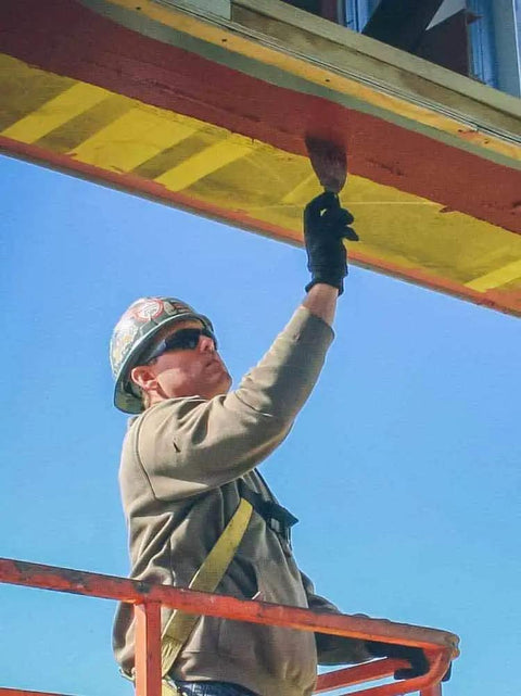 Worker applying FastFlash Fluid Applied Flashing Membrane For Windows Waterproof And Airtight Pro Grade Sealant on construction site