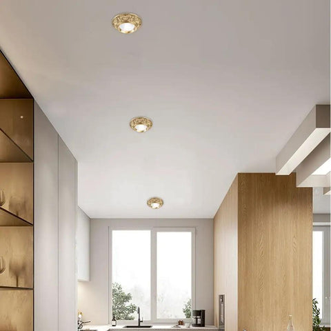 Three Top Notch 10 Pack Brass Led Downlights, 10W Eyeball Retrofit Spot Lights installed in sleek kitchen ceiling.