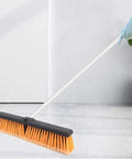 Heavy Duty 18 Inch Push Broom Long Handle Dual Bristle Gear For Concrete Garage Warehouse And Driveway Cleanup Shop Floor Workhorse Weekend Warrior Grime Getter Rig with orange bristles on a clean floor.