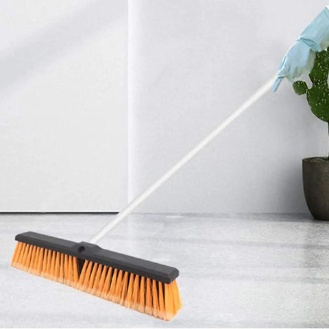 Heavy Duty 18 Inch Push Broom Long Handle Dual Bristle Gear For Concrete Garage Warehouse And Driveway Cleanup Shop Floor Workhorse Weekend Warrior Grime Getter Rig with orange bristles on a clean floor.
