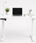 Built Like A Tank 55 Inch White Electric Standing Desk With Height Adjustable Reinforced Frame and Smart Memory Buttons for Hella Stable Computing Setup.