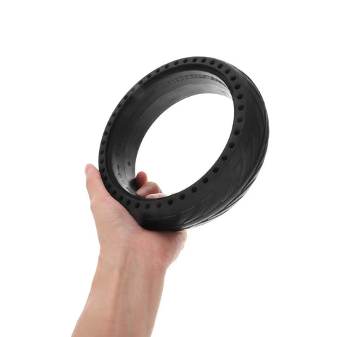 Person holding a Replacement Wheel For Electric Scooter With Honeycomb Tire And Shock Absorption Sturdy Black Rubber Wheel Easy Install
