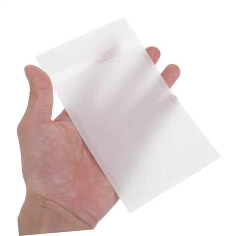 Clear Glassine Envelopes 200 Pack Self Sealing Small Paper Bags For Treats Seeds Cards Invitations And Mailings held in a hand