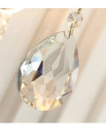 Close-up of a crystal pendant, showcasing its faceted surface, part of a wall sconce decor lighting fixture.