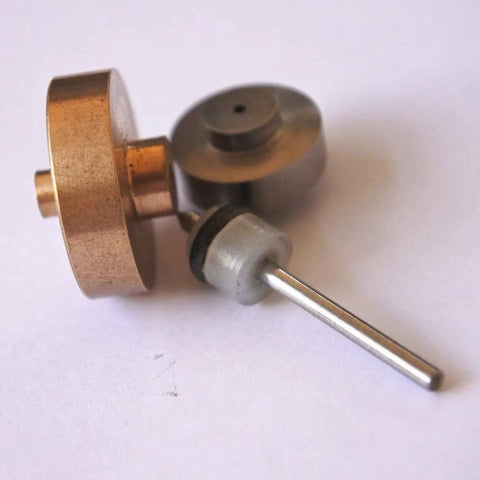 On/off valve part with copper disk and silver shaft; gray O-ring collar.