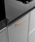 5 Inch Champagne Bronze Cabinet Pull Handles 6 Pack With Grooved Texture And Non Slip Grip For Farmhouse And Industrial Cabinetry Decorative Hardware For Cabinets And Dressers, installed on a kitchen cabinet.