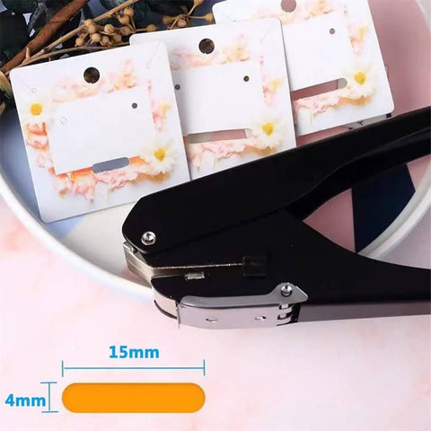 Black Metal Oval Single Hole Punch 4 15mm Hole Puncher Workhorse With Lever Action shown with punched cards