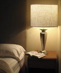 DIY Linen Drum Lamp Shade 13 Inch Top 13 Inch Bottom 10 Inch High Easy To Set Up For Table Lamp Bedside Lamp And Floor Lamp Fabric Replacement Lampshade With Spider Fitter Classic Modern Style shown on a bedside table.