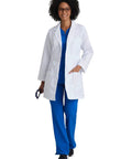 Woman wearing Lily White Lab Coat For Women With Natural Stretch 34 Inch 4 Pocket Scrub Coat Soil Release Fabric Finish Soft Touch Back Vent.