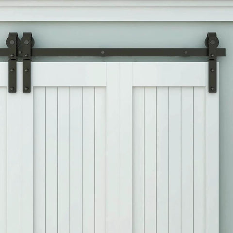 Front view of Heavy Duty Bi Folding Barn Door Hardware Kit For Double Doors, Matte Black track installed on white doors