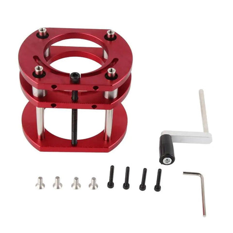 No Sweat Four Jaw Router Table Lift Base in red aluminum, showing components and tools for precision woodworking setup.