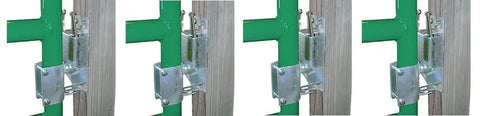 Heavy Duty Two Way Livestock Gate Latch Four Pack Lockable Farm Fence Hardware on green fencing, showing one handed operation.