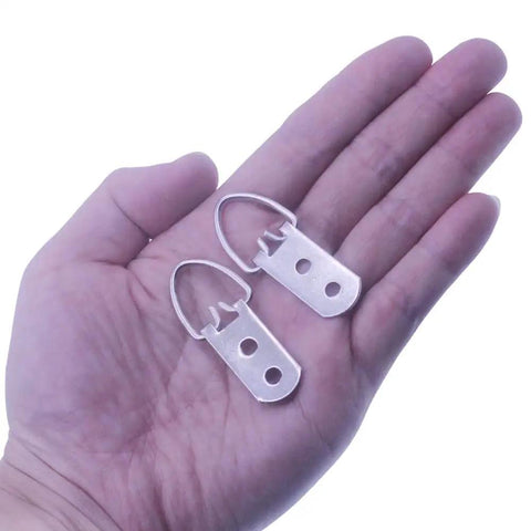Heavy Duty D Ring Picture Hangers With Included Wall Screws, 20 Pack, large silver hardware held in hand for art mounting.