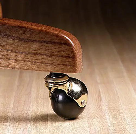 Get Your Furniture Rolling Smooth With 2 Inch Rubber Ball Casters Heavy Duty 80 Lb Rating Bright Brass Hood And 5 16 X 1 1 2 Friction Stem Swivel For Couches And Chairs 2 Pack close-up of black rubber ball caster with brass hood.