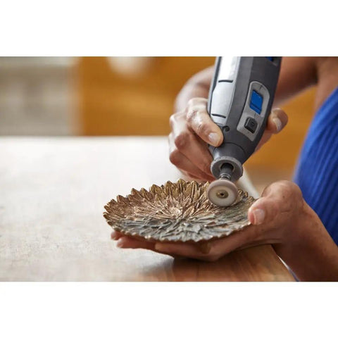 Person using EZ Lock Sanding And Polishing Rotary Accessory Kit on a metal dish for fast change sanding, buffing, and polishing.