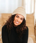 Woman wearing Satin Lined Beanie For Curly Hair Women Cozy Cable Knit Winter Hat With Frizz Free Moisture Retaining Satin Interior Curly Girl Method Approved