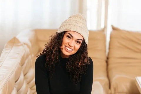 Woman wearing Satin Lined Beanie For Curly Hair Women Cozy Cable Knit Winter Hat With Frizz Free Moisture Retaining Satin Interior Curly Girl Method Approved