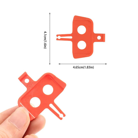 Close-up of red plastic piece from 8 Piece Bike Disc Brake Pad Spacer Set for Hydraulic Systems Go To Spreader Insert Tool Shimano Compatible
