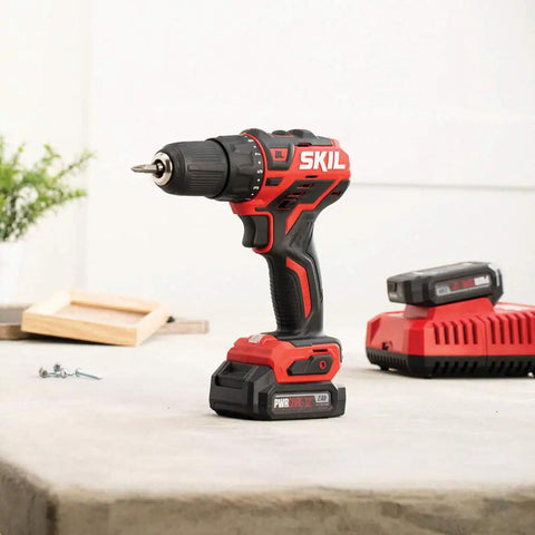 Two Tool Cordless Drill And Right Angle Impact Kit with 12V brushless power displayed on a table with charger and accessories